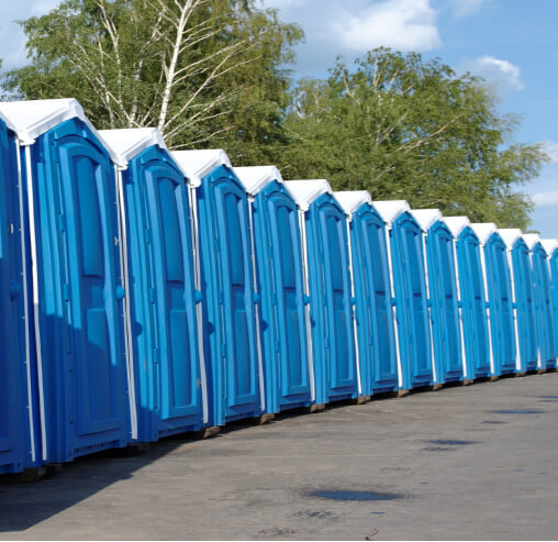 Stacked cardboard boxes on a recycling bin for commercial waste disposal services.
